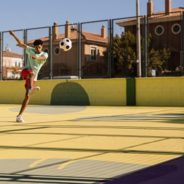 portrait-young-man-playing-football